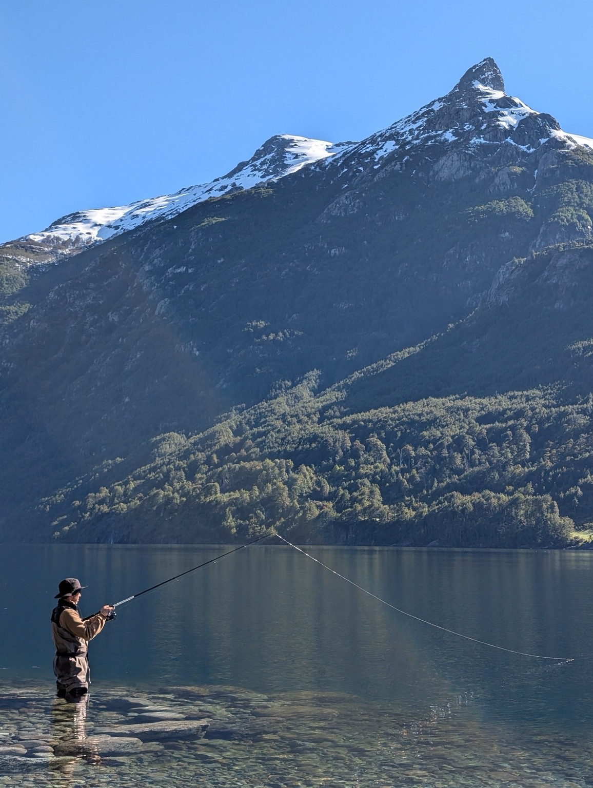 A cast beneath the mountains
