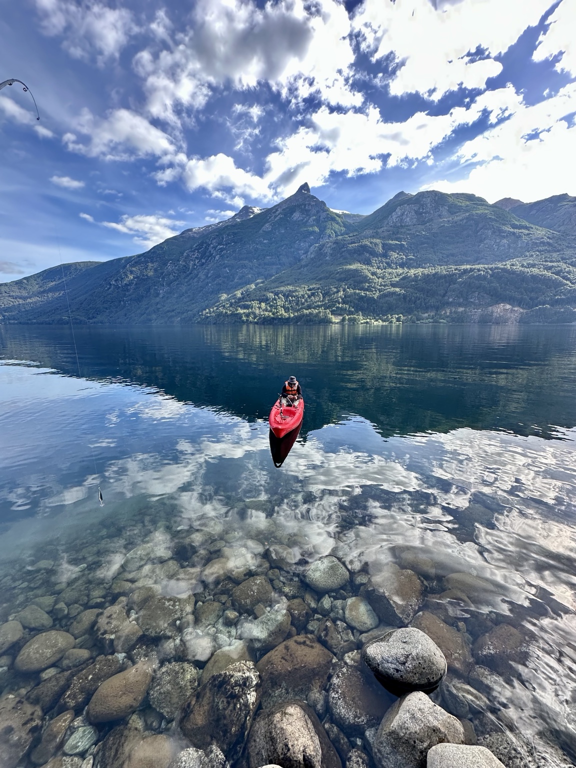 A kayak on a mirror-still lake